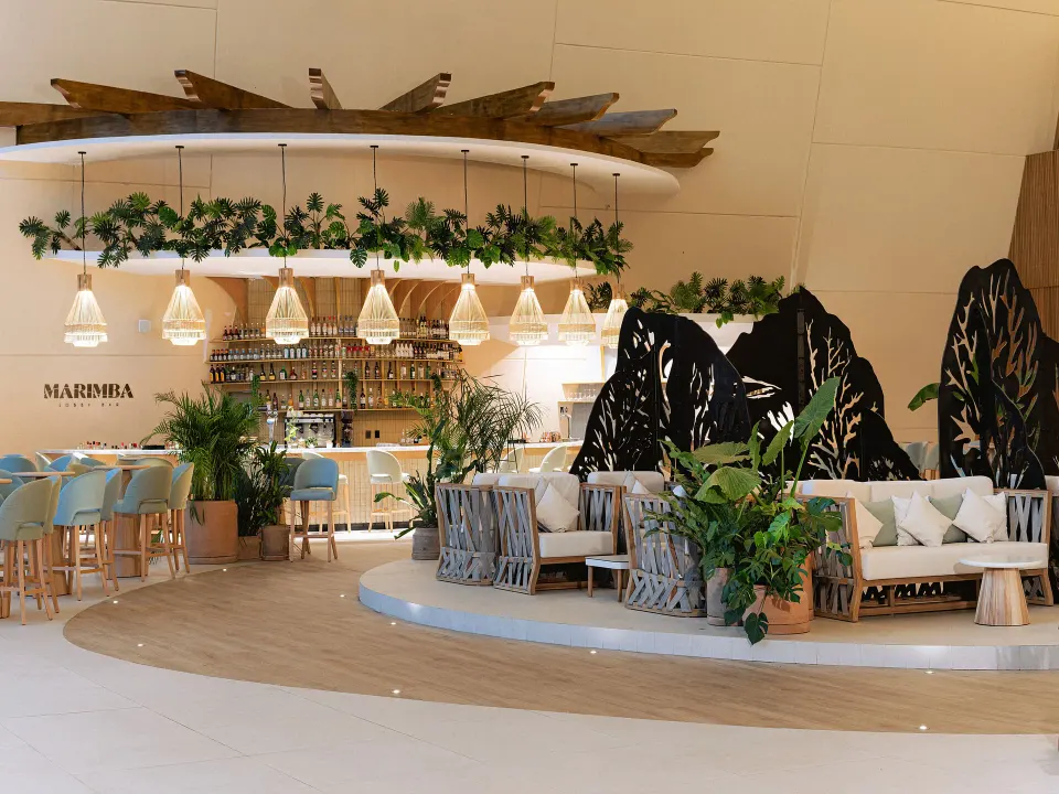 Marimba bar seating and counter with hanging lights at Grand Sirenis Riviera Maya Resort & Spa