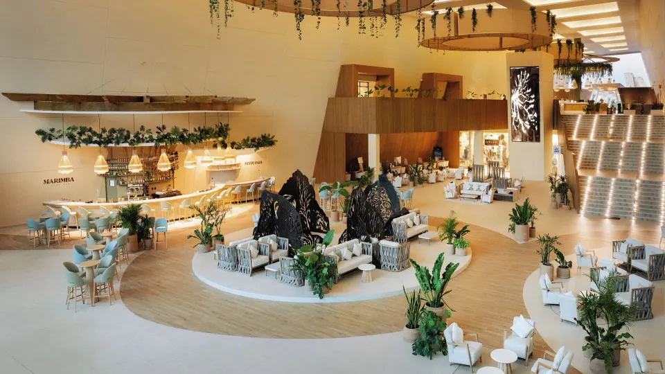 Open lounge area with seating and a named Marimba bar at Grand Sirenis Riviera Maya Resort & Spa
