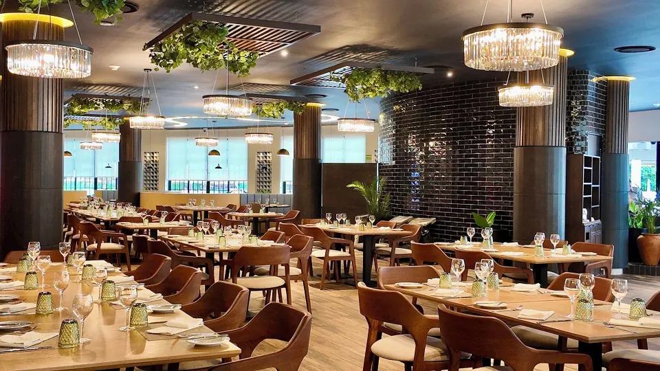 Spacious modern dining room with chandeliers at Grand Sirenis Riviera Maya Resort & Spa