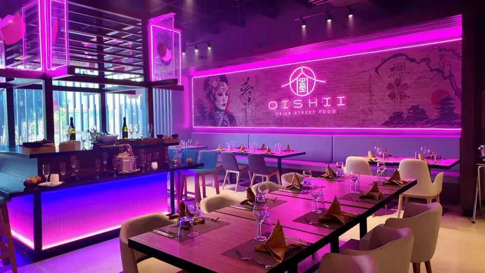 Neon-lit Oishii dining room with purple lighting at Grand Sirenis Riviera Maya Resort & Spa
