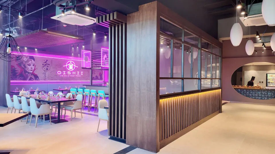 Entrance view into Oishii showing neon-lit dining and partitioned seating at Grand Sirenis Riviera Maya Resort & Spa