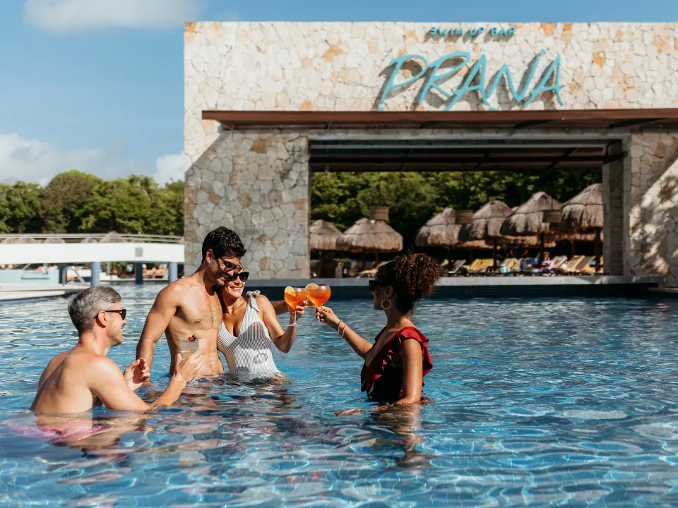 Guests enjoying drinks in the Prana swim-up bar pool at Grand Sirenis Riviera Maya Resort & Spa