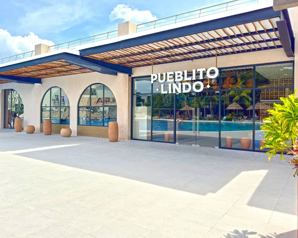 Entrance to Pueblito Lindo restaurant with pool reflections at Grand Sirenis Riviera Maya Resort & Spa