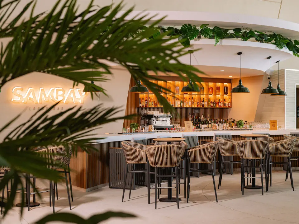 Sambay bar interior with stools and neon sign at Grand Sirenis Riviera Maya Resort & Spa