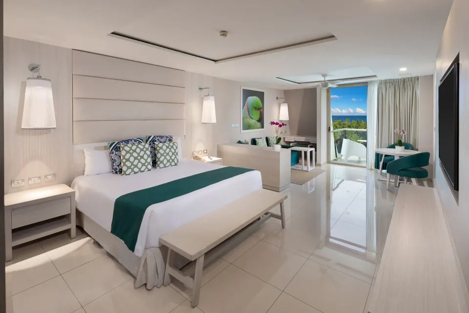 Deluxe Junior Suite ocean view king bed and lounge area with balcony at Grand Sirenis Riviera Maya Resort & Spa