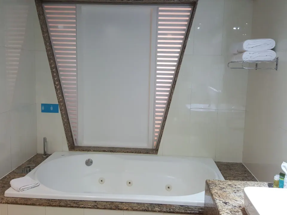 In-room jetted bathtub with privacy shade at Grand Sirenis Riviera Maya Resort & Spa