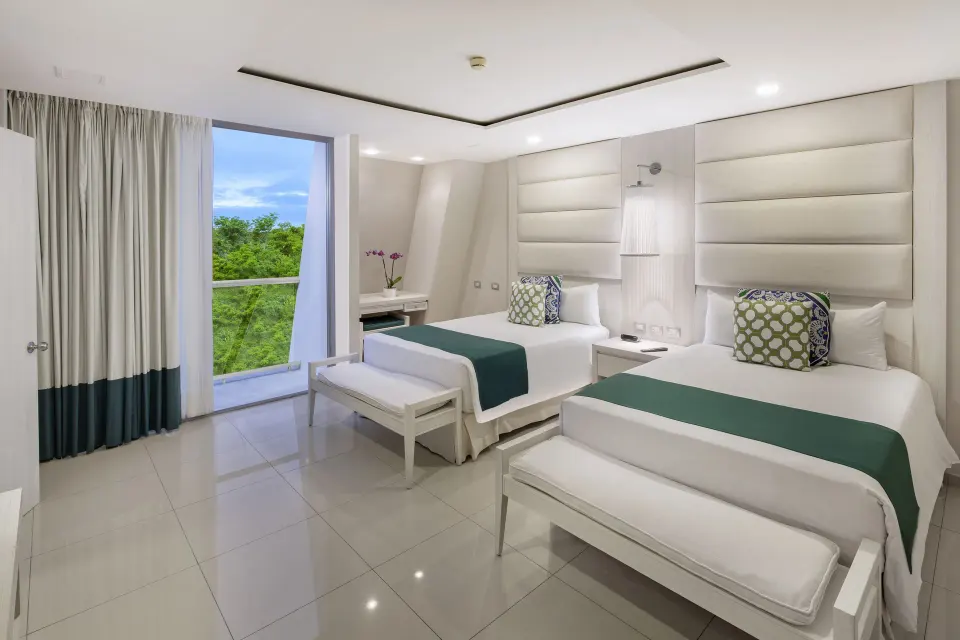 Bright mini suite twin beds with balcony at Grand Sirenis Riviera Maya Resort & Spa
