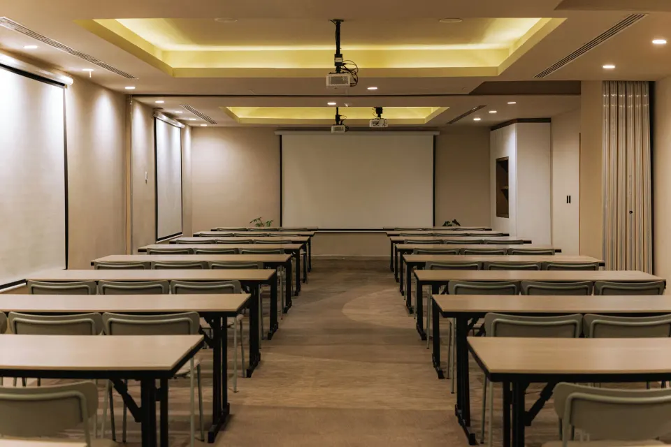 Conference room set classroom-style with projector and screen at Grand Sirenis Riviera Maya Resort & Spa