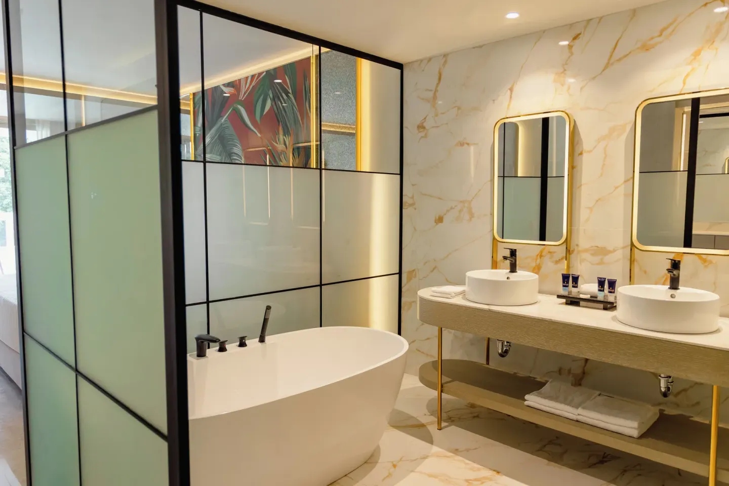 Bathroom with freestanding tub, double sinks and gold-framed mirrors at Grand Sunset Princess.