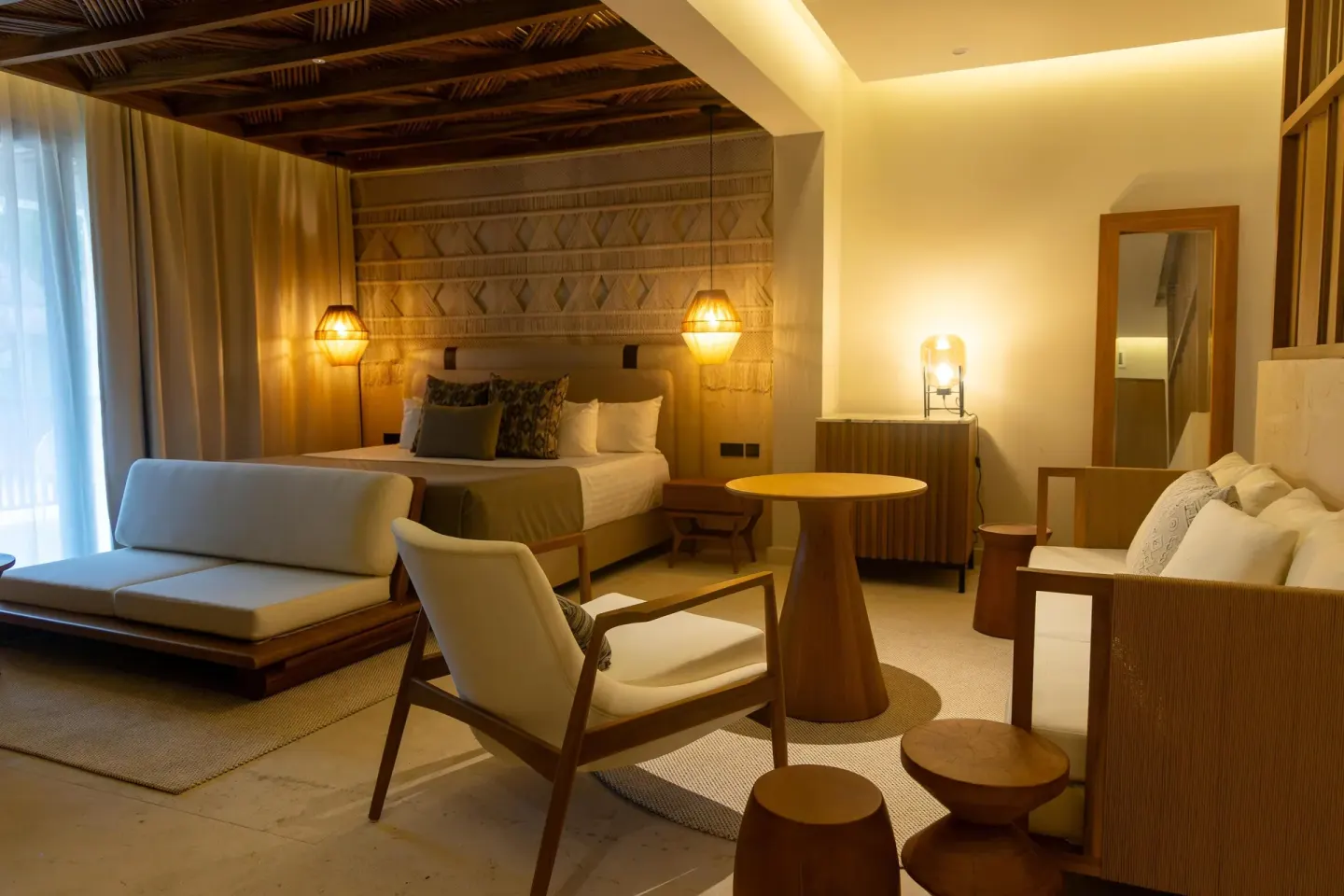 Guest room with king bed, daybed, chairs and round table at Grand Sunset Princess.