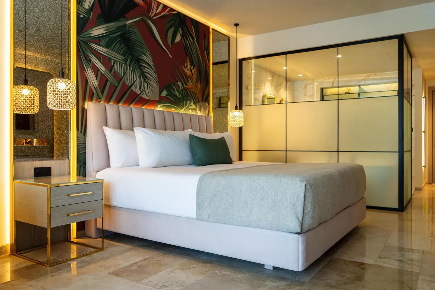 King bed with tropical headboard wall in a guest room at Grand Sunset Princess.