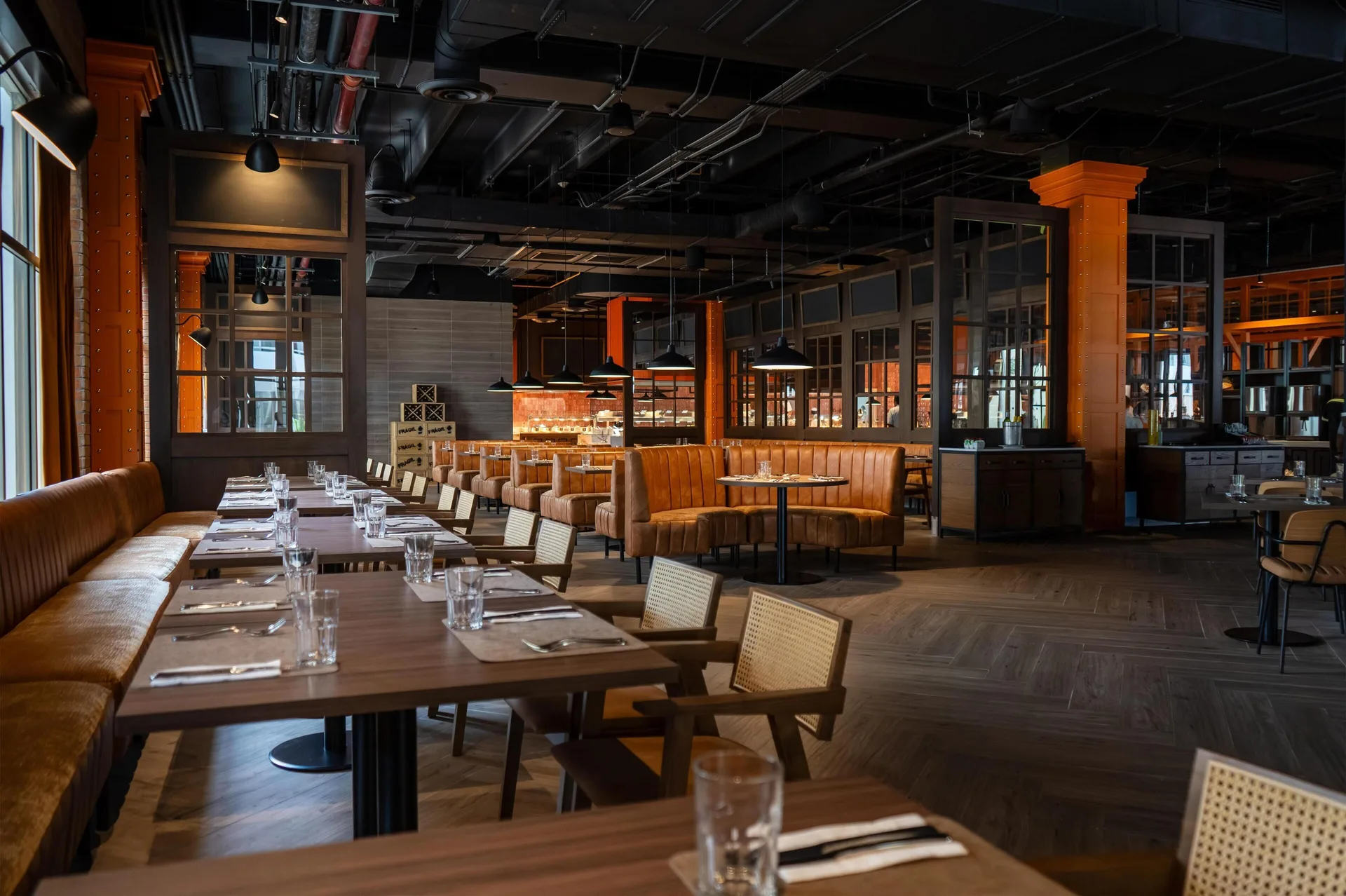 Set tables and booth seating in a spacious restaurant at Grand Sunset Princess.