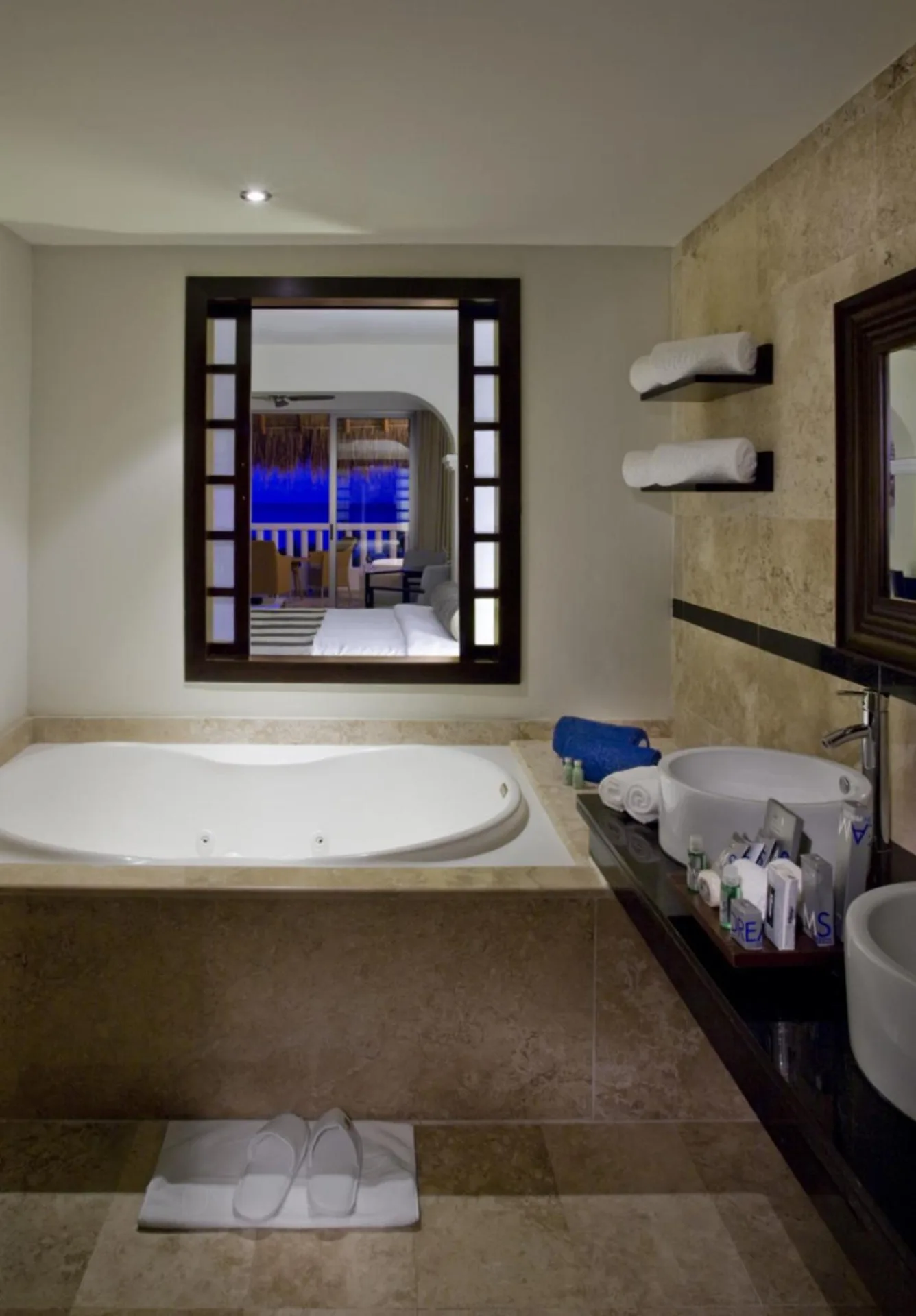 Deluxe Junior Suite bathroom with jetted tub, vanity and towel shelves at Grand Sunset Princess.