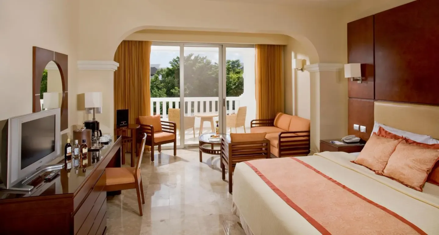 Deluxe Junior Suite with king bed, seating area, TV and balcony at Grand Sunset Princess.