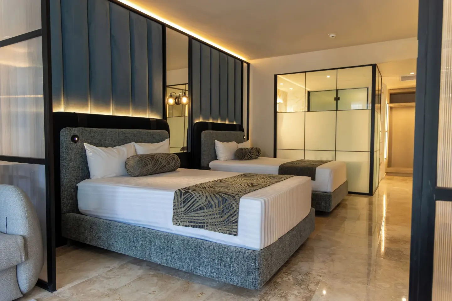 Two beds and glass bath partition in a Platinum Suite Plunge Pool room at Grand Sunset Princess.