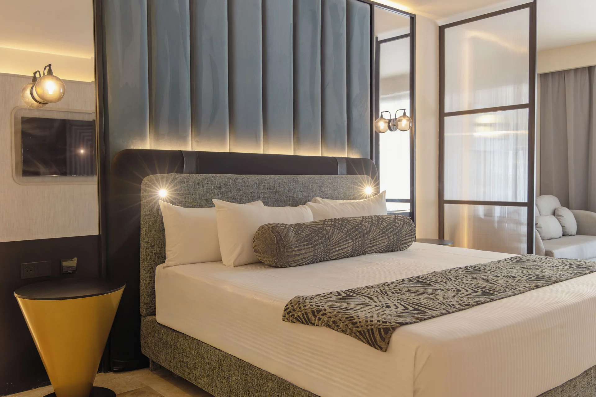 Platinum Suite king bed with padded headboard and side table at Grand Sunset Princess.