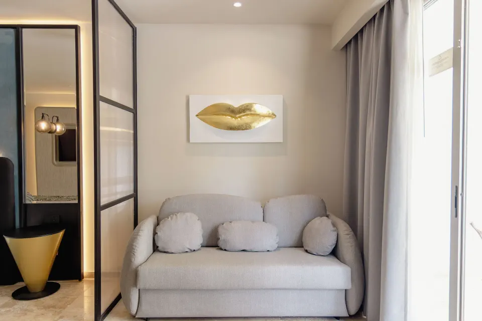 Platinum Suite sitting area with sofa and gold wall art at Grand Sunset Princess.