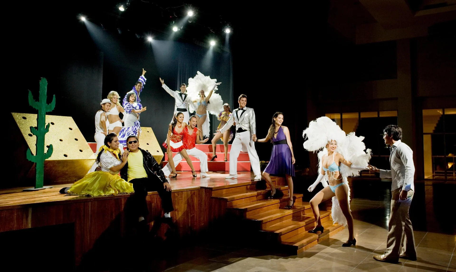 Costumed performers pose on a theater stage at Grand Sunset Princess.