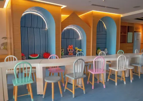 Children's activity room at Grand Velas Los Cabos with pastel chairs and arched seating nooks.