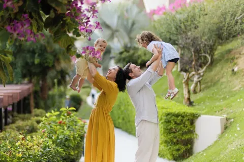 Family playing on a landscaped garden path at Grand Velas Los Cabos.