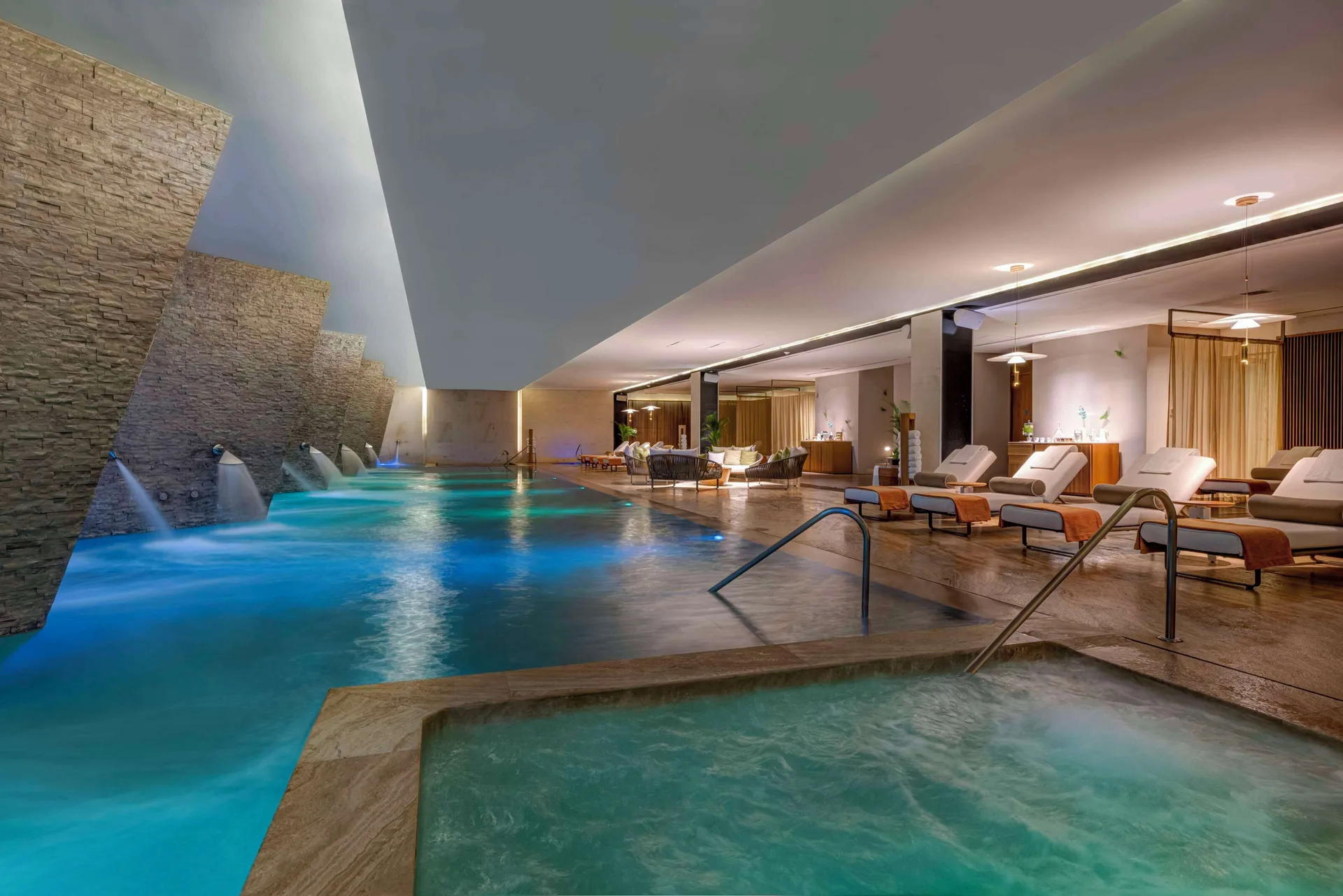 Indoor spa pool and whirlpool with illuminated water features at Grand Velas Los Cabos.