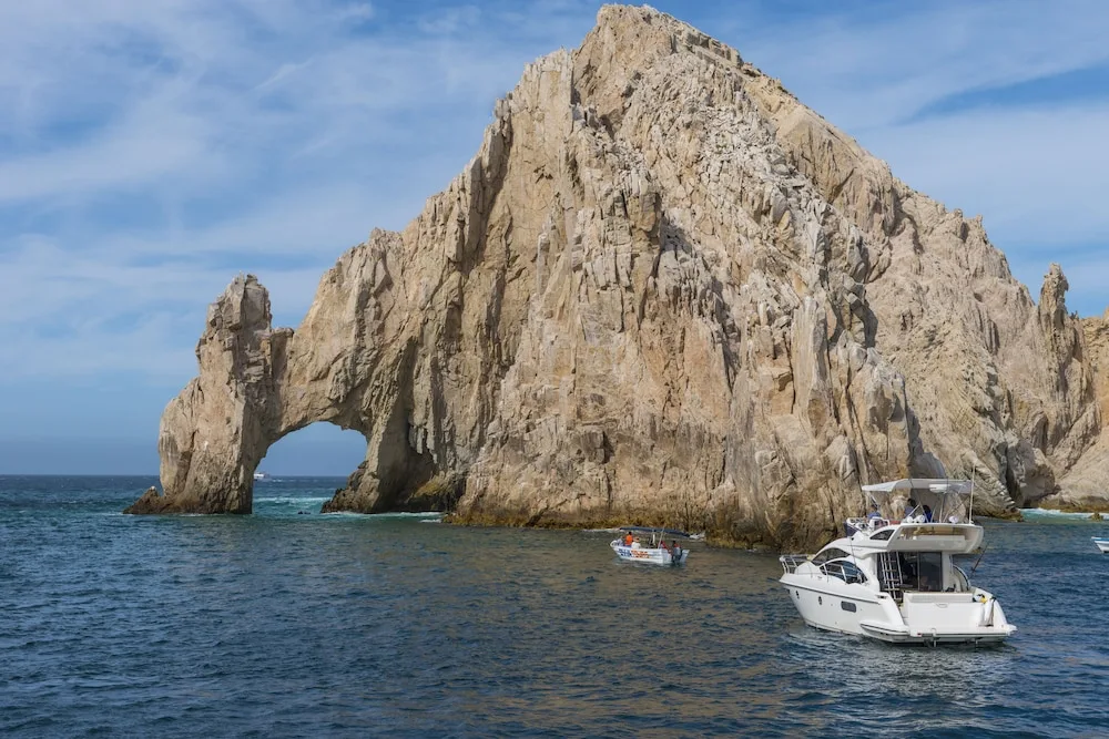 Rock arch and boats off the Los Cabos coast near Grand Velas Los Cabos.