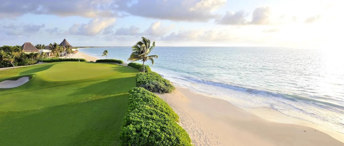 Beachfront golf green beside the Caribbean at Grand Velas Riviera Maya.