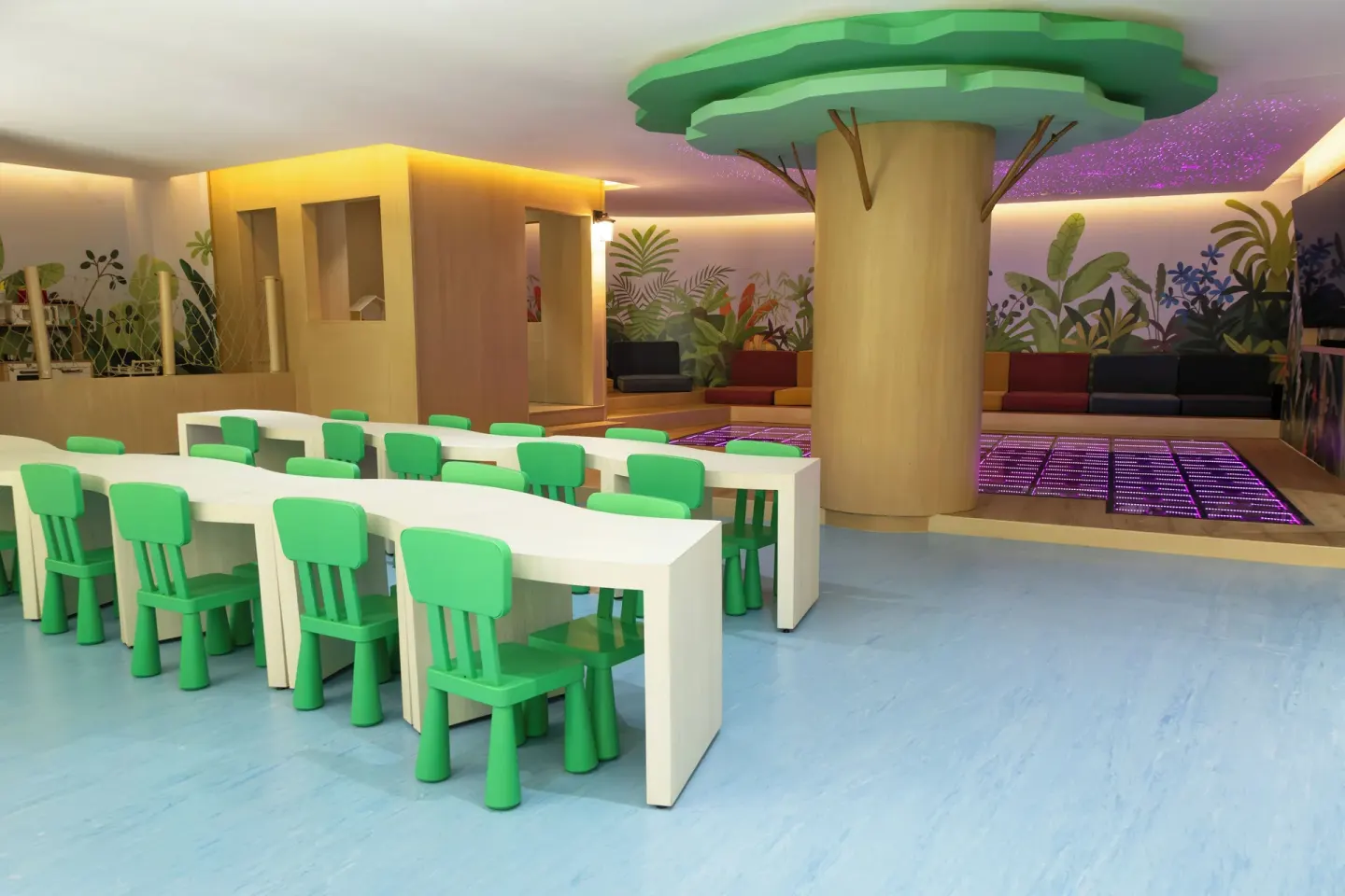 Children’s classroom area with green chairs and lighted floor at Grand Velas Riviera Maya.