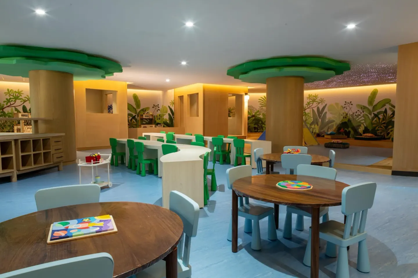Children’s playroom with small tables, chairs and murals at Grand Velas Riviera Maya.