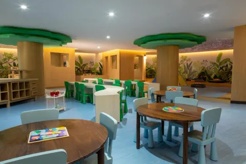 Children’s playroom with small tables, chairs and murals at Grand Velas Riviera Maya.
