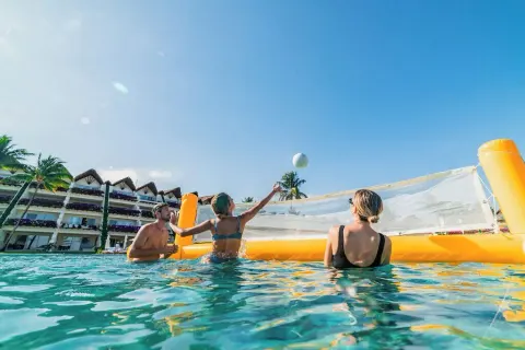 Guests play volleyball in the pool at Grand Velas Riviera Maya.