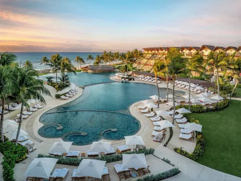 Sunset view of the main pool terraces and ocean beyond at Grand Velas Riviera Maya.