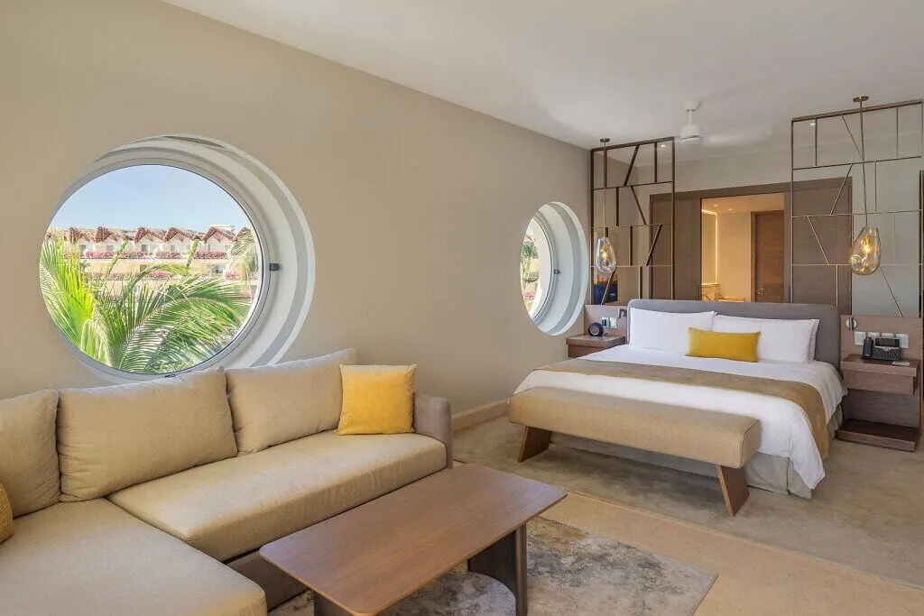 Ambassador Pool Suite Ocean View bedroom and sofa at Grand Velas Riviera Maya.