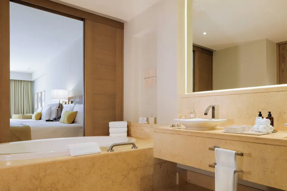 Ambassador Suite Ocean View bathroom with tub and vanity at Grand Velas Riviera Maya.