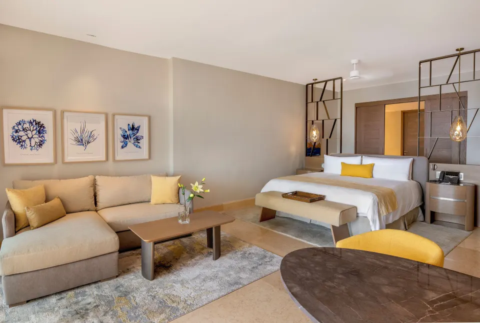 Ambassador Suite Ocean View with king bed and sofa at Grand Velas Riviera Maya.