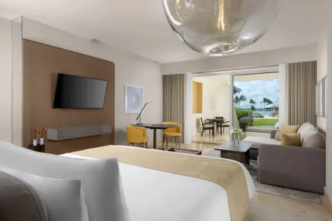 Ambassador Suite Ocean View with king bed, sofa, and terrace at Grand Velas Riviera Maya.