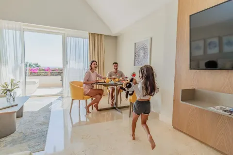 Family suite dining area with terrace doors at Grand Velas Riviera Maya.