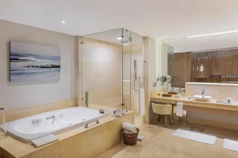 Grand Class Pool Suite Ocean Front bathroom with tub and glass shower at Grand Velas Riviera Maya.