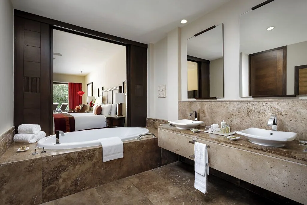 Nature View Suite bathroom with twin sinks and tub at Grand Velas Riviera Maya.