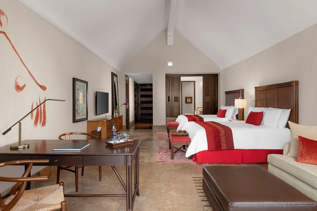 Nature View Suite with two beds, desk, and sofa at Grand Velas Riviera Maya.