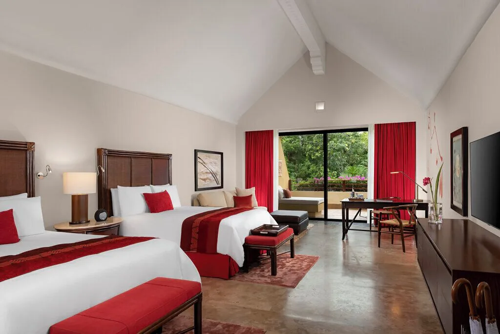 Nature View Suite with two beds and garden-facing glass doors at Grand Velas Riviera Maya.