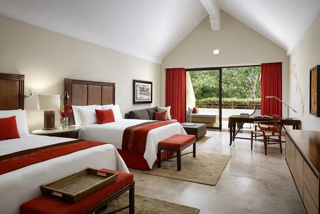 Nature View Suite with two beds, sofa, and balcony at Grand Velas Riviera Maya.