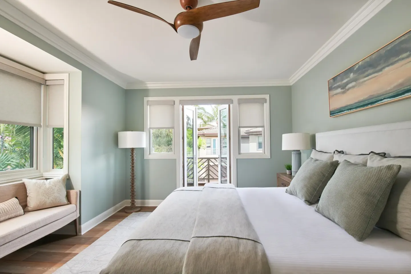 Guest room with a bed, daybed, ceiling fan, and balcony doors at Grand Wailea Maui.