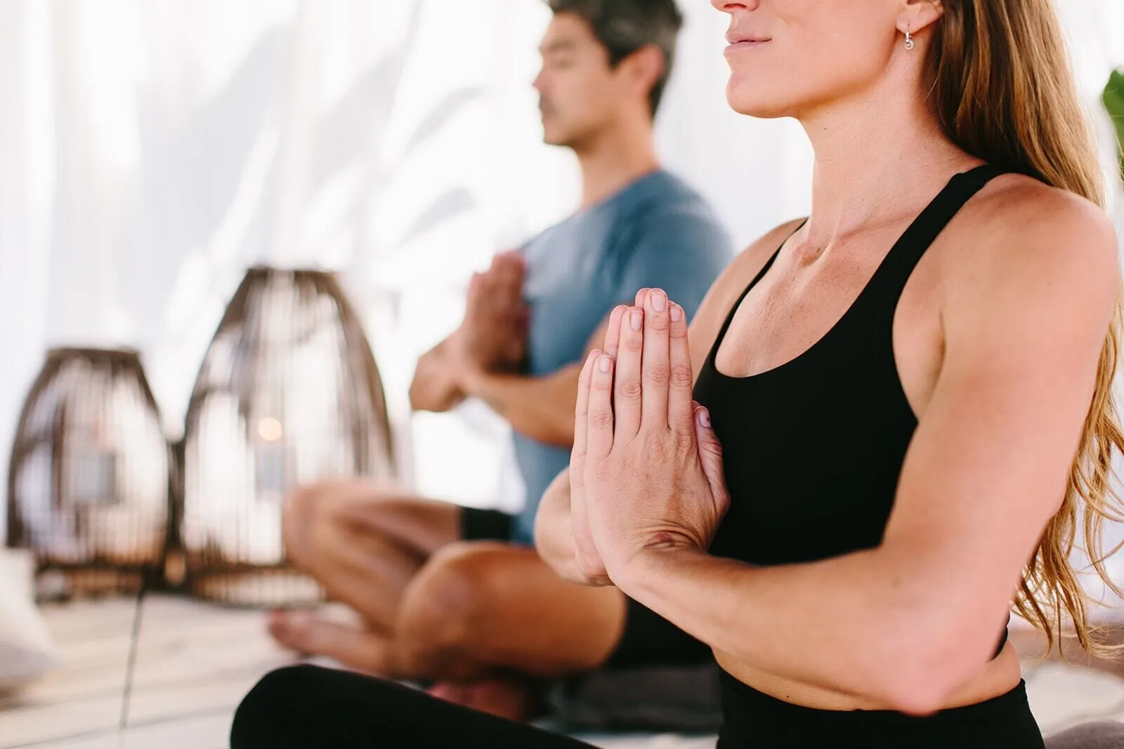 Close-up of two guests seated in a meditation pose at Grand Wailea Maui.