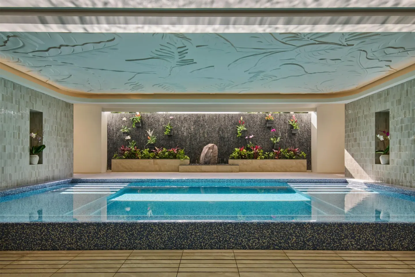 Indoor spa pool with a planted wall and carved ceiling at Grand Wailea Maui.