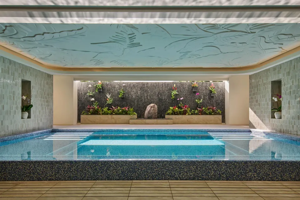 Indoor spa pool with a planted wall and carved ceiling at Grand Wailea Maui.