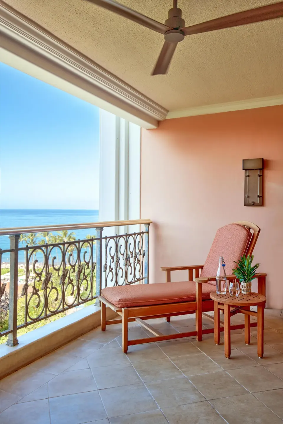 Ocean-view balcony with chaise lounge and table at Grand Wailea Maui.