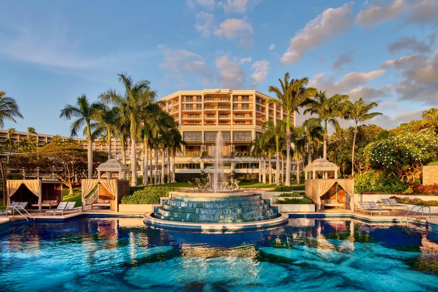 Resort pool, fountain, cabanas, and hotel tower at Grand Wailea Maui.