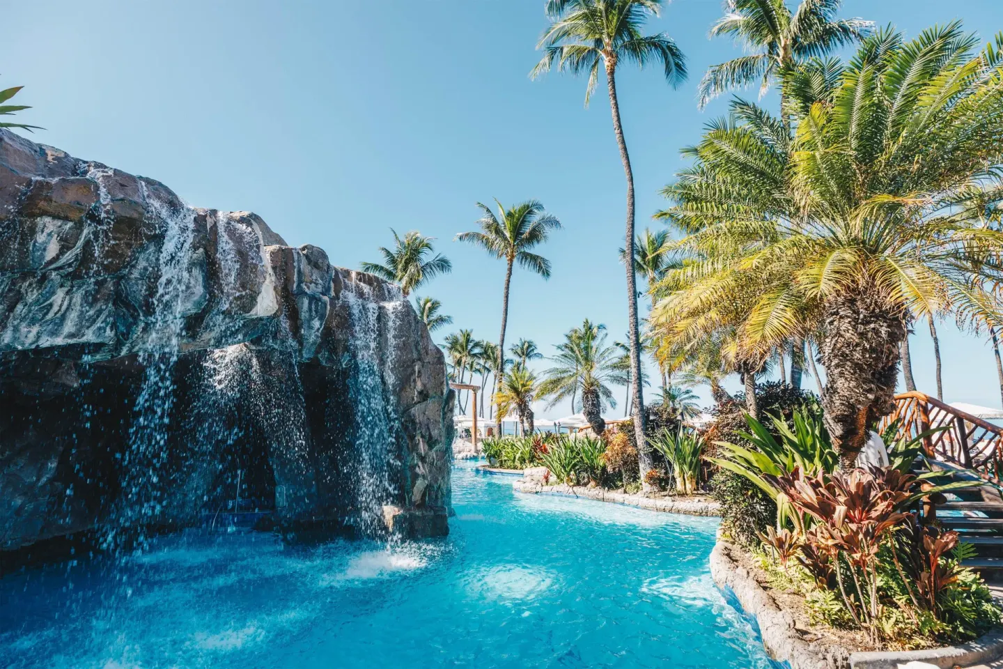 Rock waterfall flowing into a tropical pool at Grand Wailea Maui.
