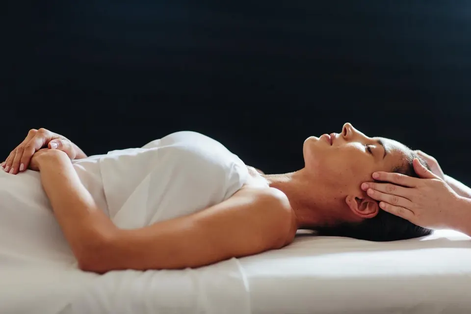 Guest receiving a head massage while lying on a spa treatment table at Grand Wailea Maui.